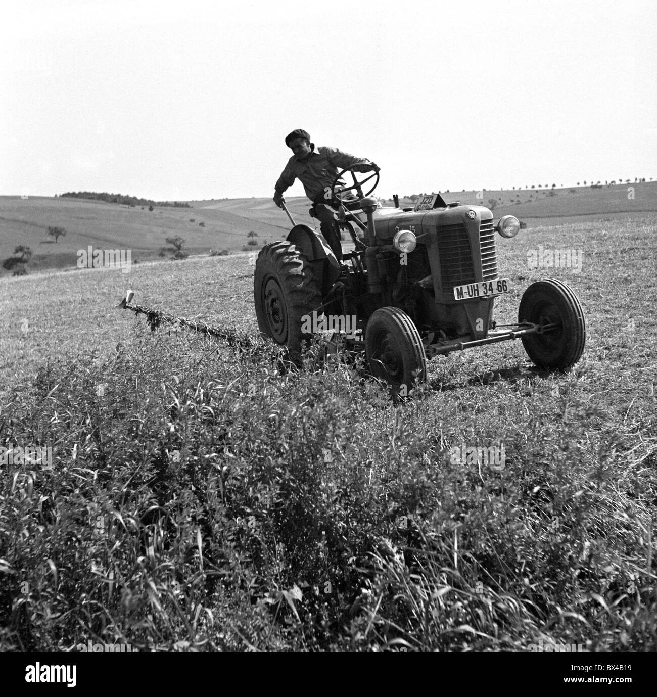 Velehrad - Czechoslovakia, 1950. Farmer harvests grass with his Zetor 25  tractor. CTK Vintage Photo Stock Photo - Alamy