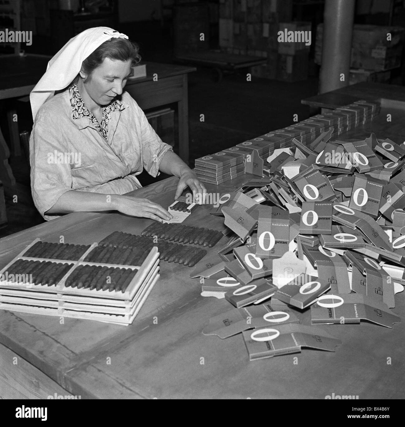 tobacco factory opera Czechoslovakia - Pisek, 1950. Woman employed by tobacco factory packs 