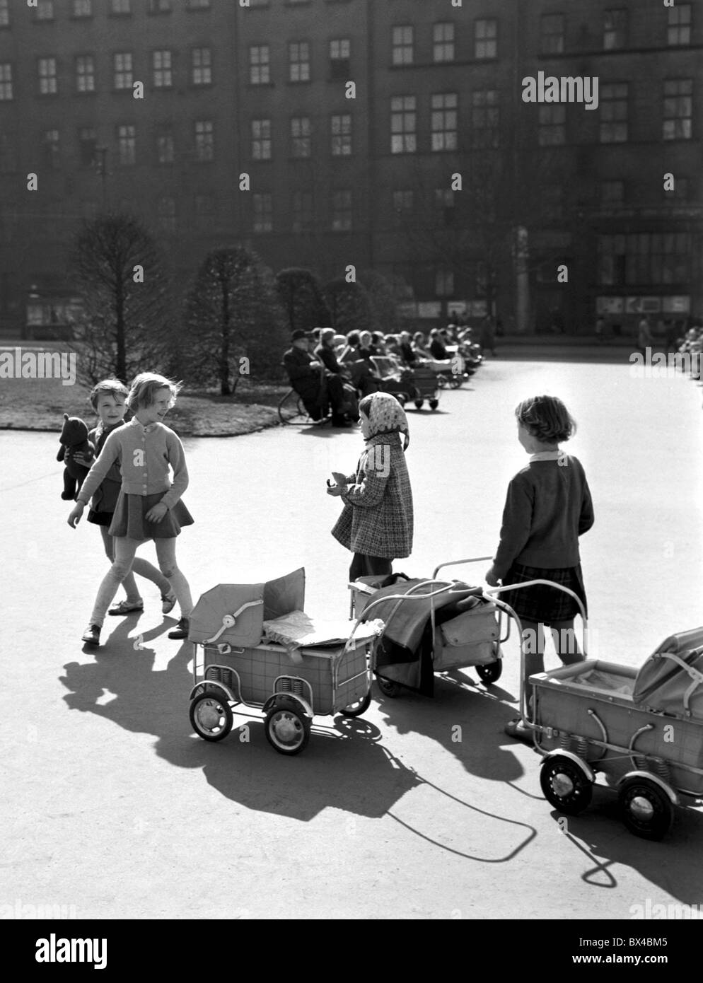 Girls play with toy carriages at the begining of Spring. Prague, Czechoslovakia. (CTK Photo / Jovan Dezort) Stock Photo