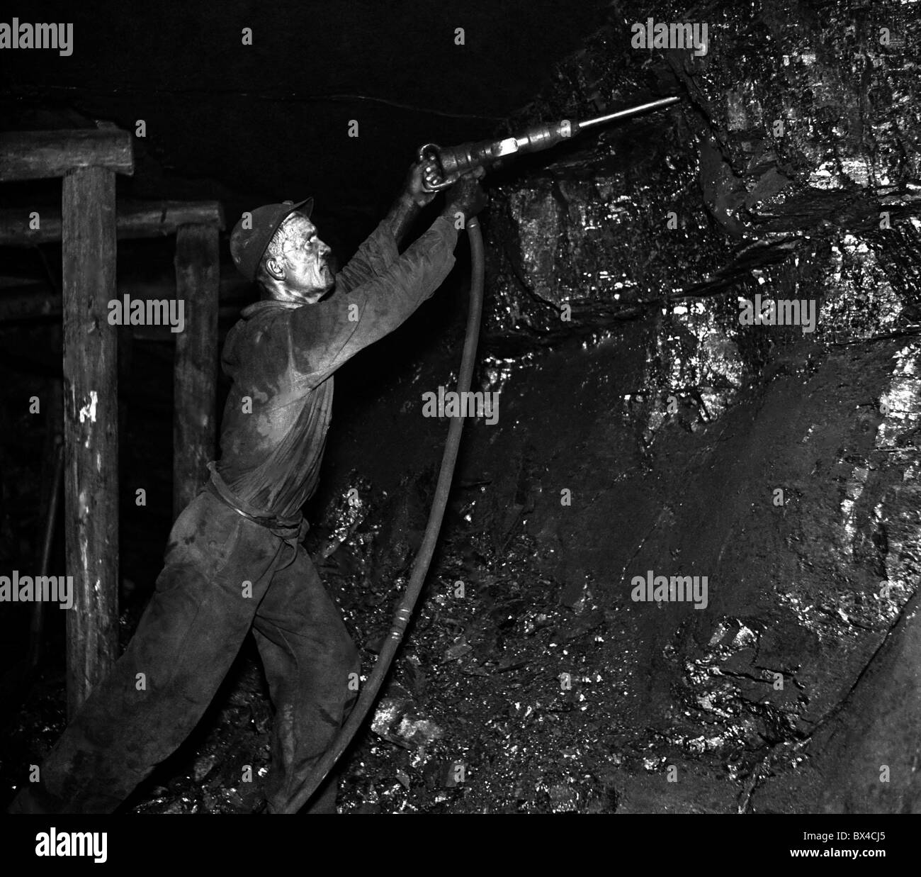 Czechoslovakia - Most, 1950. Coal miner using air hammer excavates significant amounts of coal. CTK Vintage Photo Stock Photo