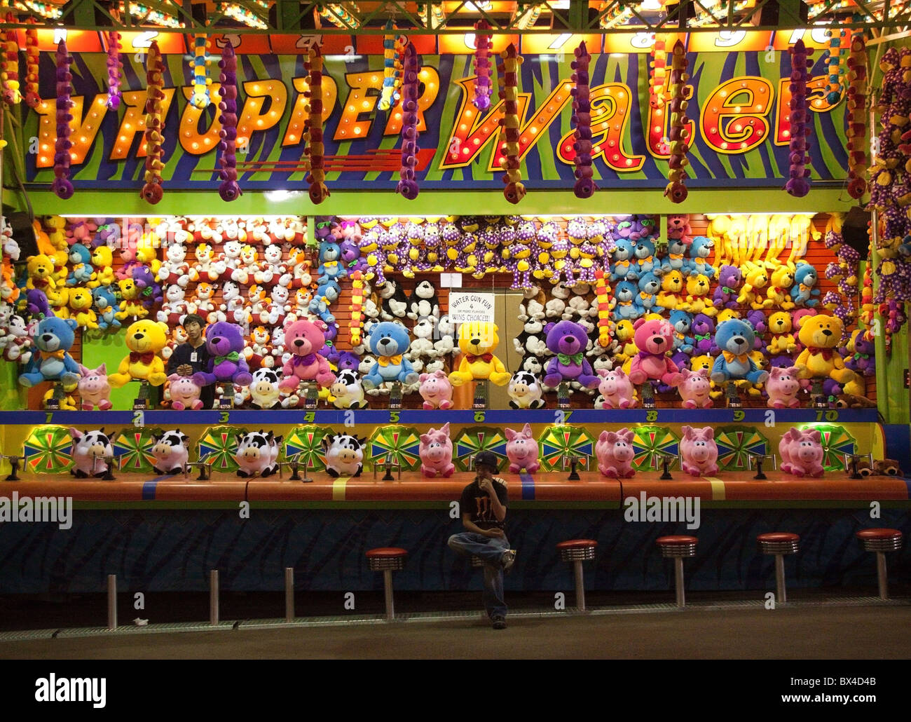 Boy waits for business at carnival game, at the North Carolina State