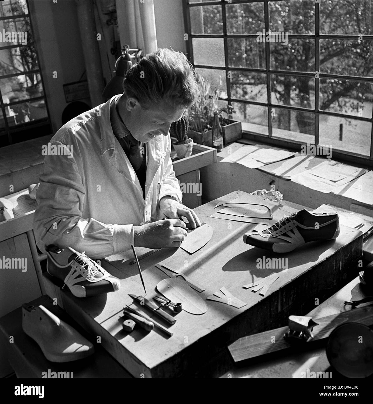 Shoemaker manufactures sport shoes in skutec hires stock photography