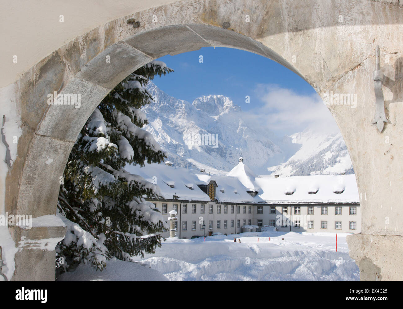 Benedictine cloister winter snow round arch Engelberg canton Obwalden Switzerland Europe mountains Alps Stock Photo