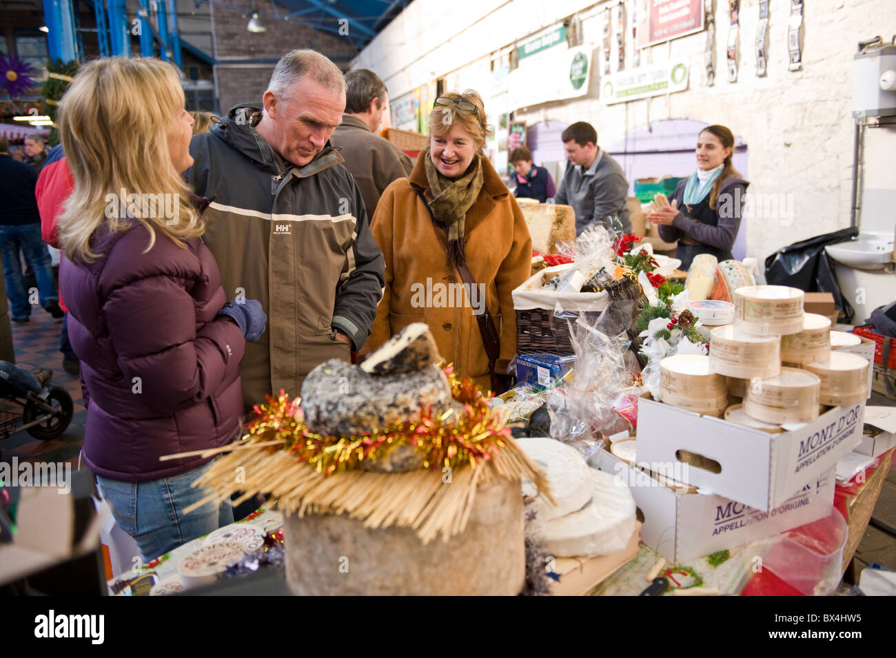 People browsing stall selling European cheeses at Abergavenny Food