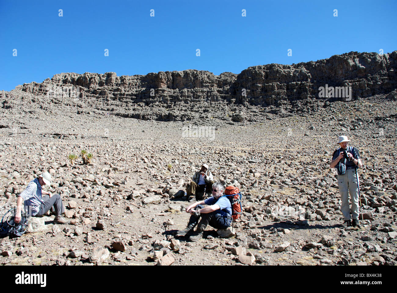 trekkers rest at the foot of Ras Deshen the highest point in the Simien mountains of Ethiopia Stock Photo