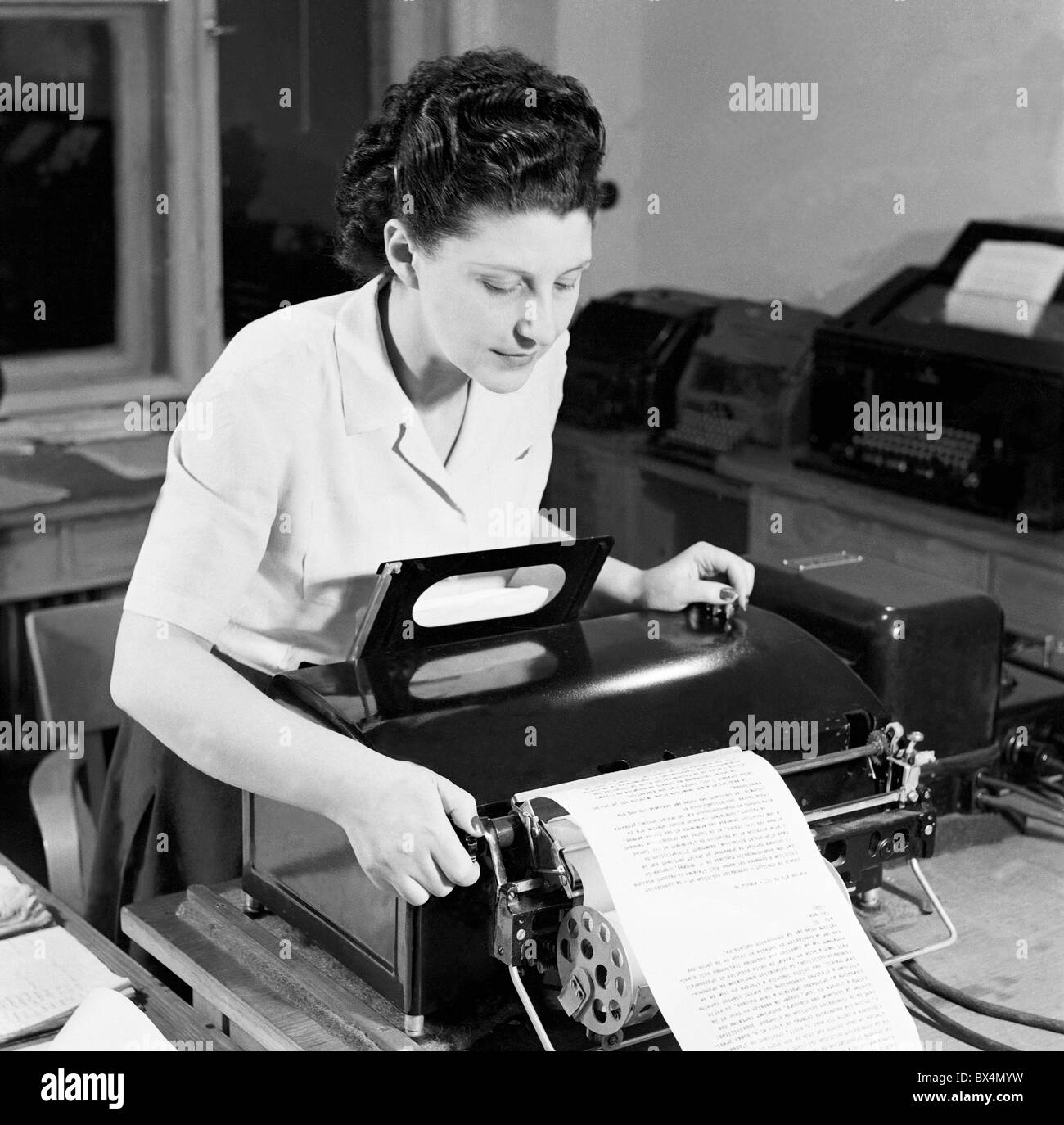 Prague, Czechoslovak News Agency. Operator reads news received by telex. CTK Vintage Photo Stock Photo