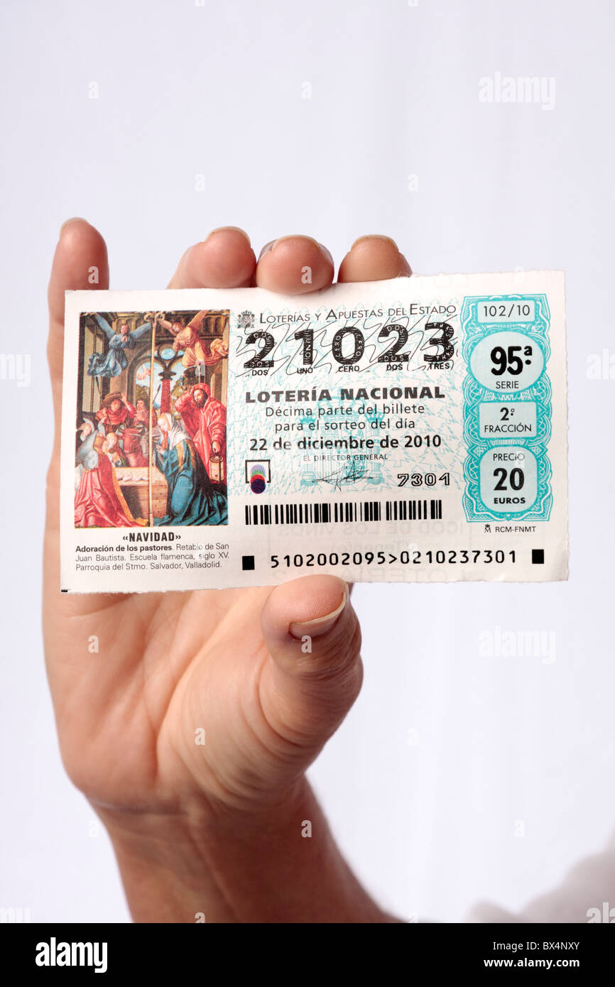 A woman holds a ticket for the El Gordo annual christmas lottery in spain Stock Photo