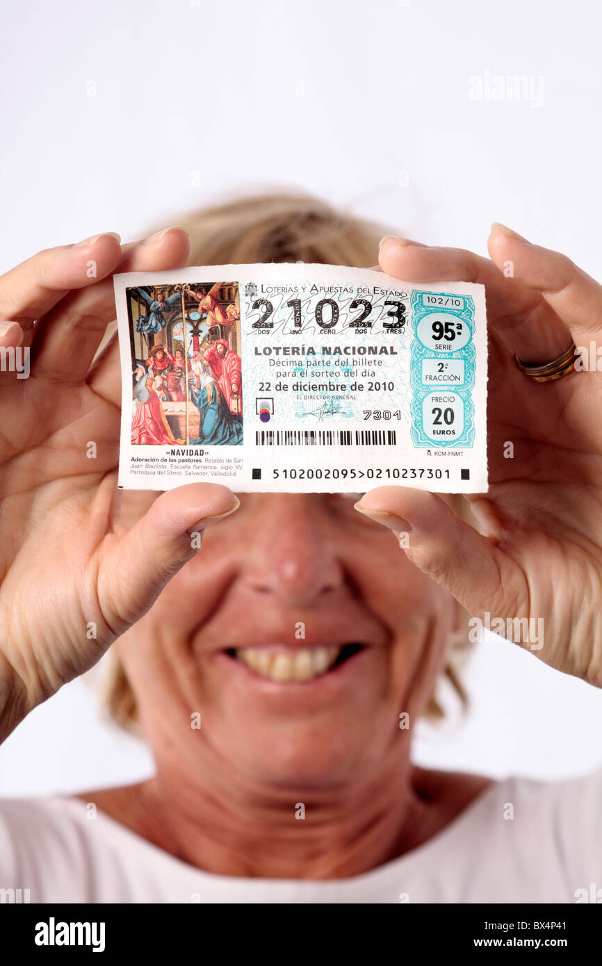 A woman holds a ticket for the El Gordo annual christmas lottery in spain Stock Photo