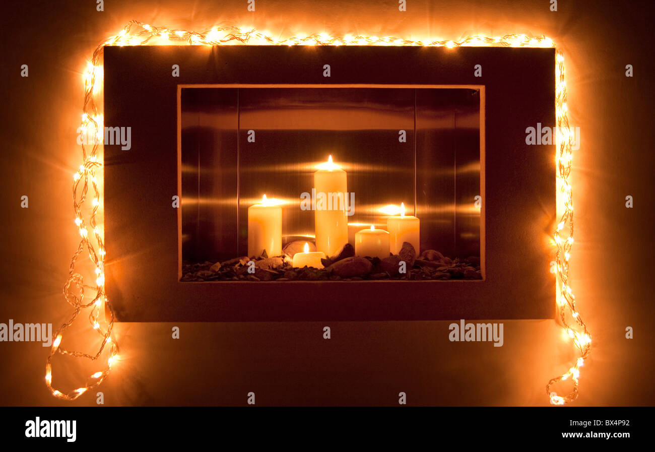 Fire Place with candles burning and fairy lights Stock Photo Alamy
