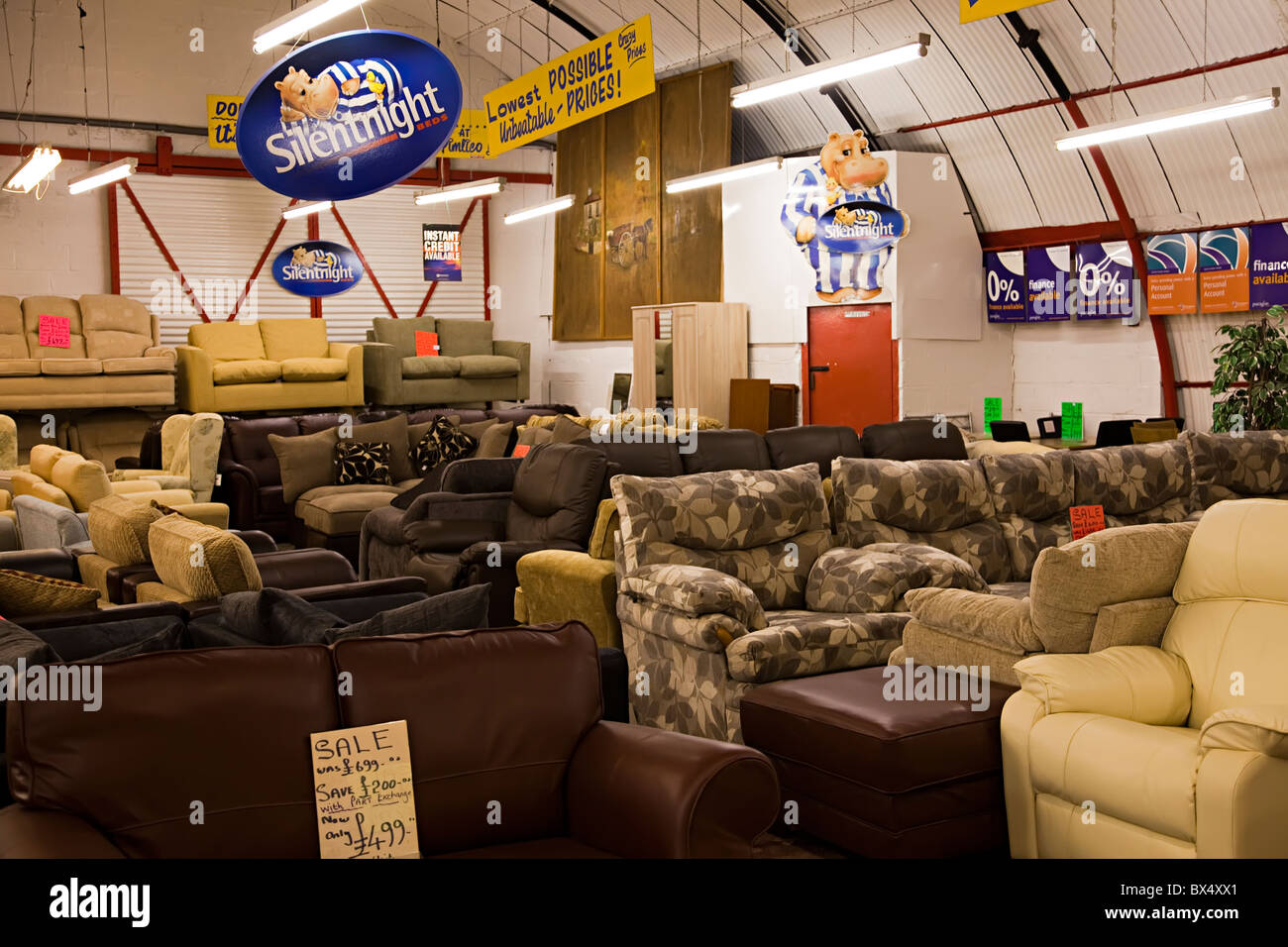 Sofas furniture on sale in warehouse Wales UK Stock Photo - Alamy