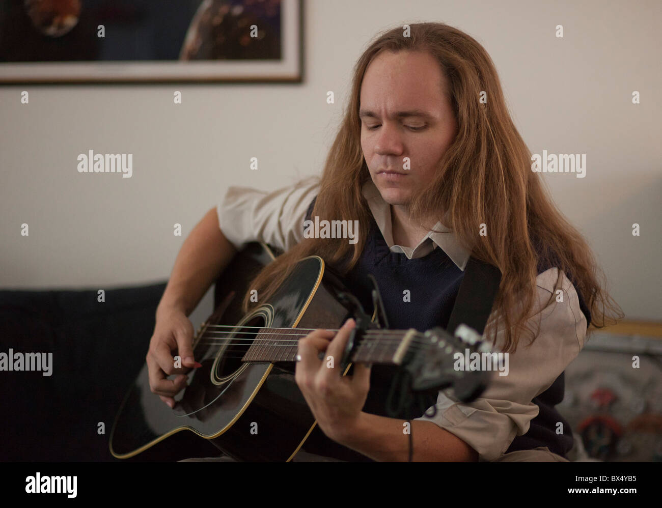 A Long Haired Man Playing The Guitar Stock Photo 33300713 Alamy