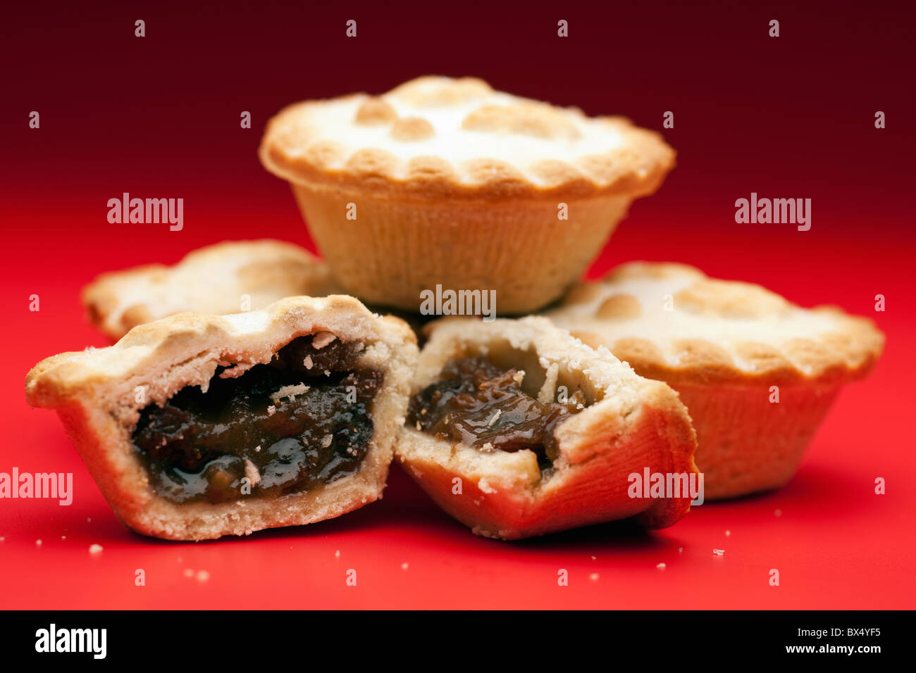 Pile of mince pies on a Graduated  Red Background Stock Photo