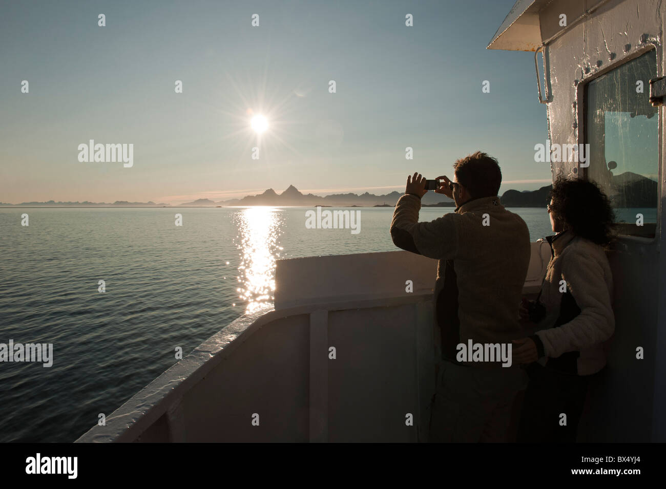 Passengers on a ferry taking photos Stock Photo