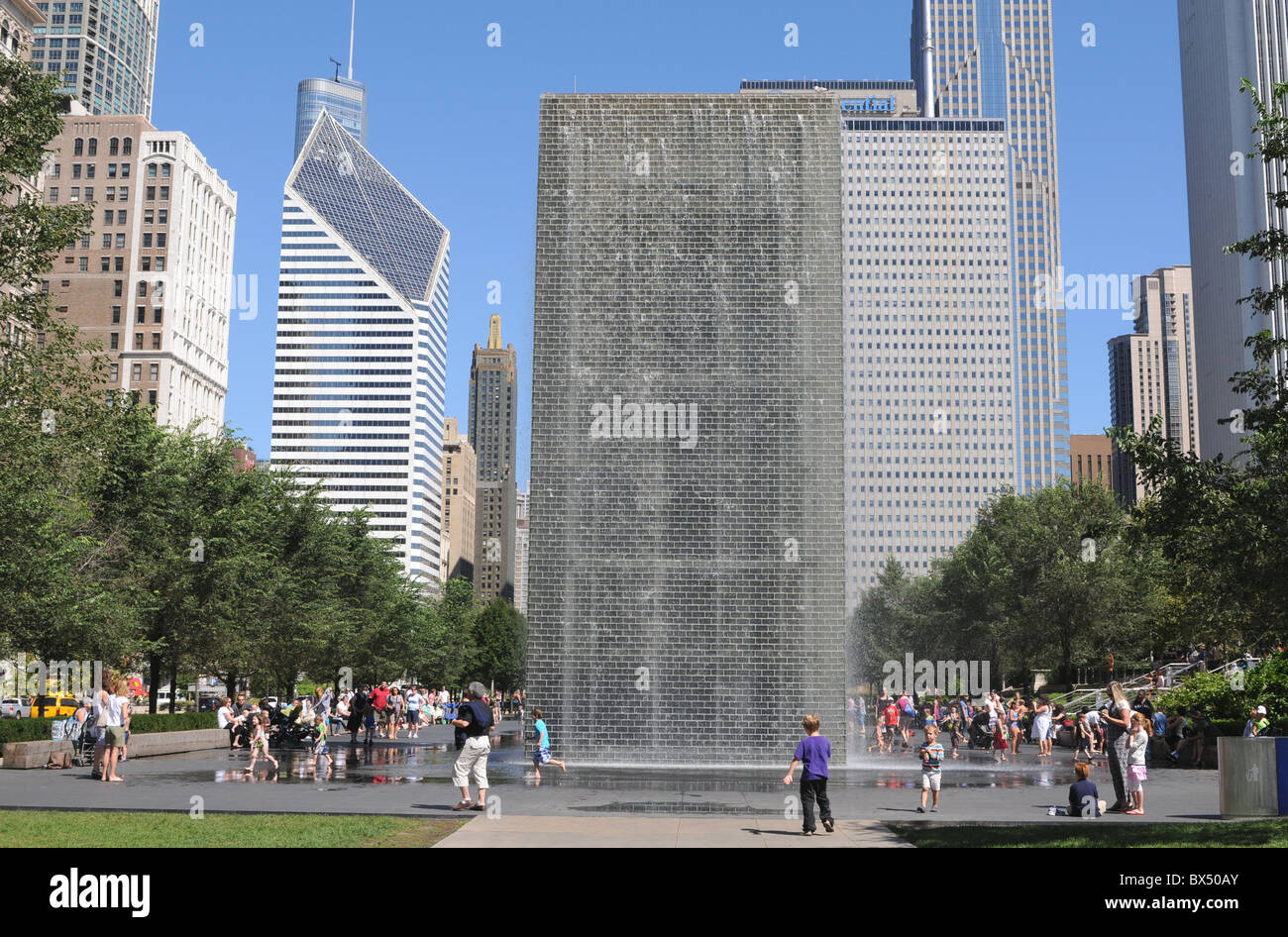 The Chicago skyline on a summer day, framed by The Crown Fountain in Millennium Park, at left, the Stone-Smurfit building Stock Photo
