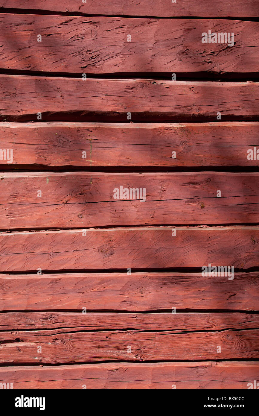 Old log cabin wall , painted with red ochre paint , Finland Stock Photo