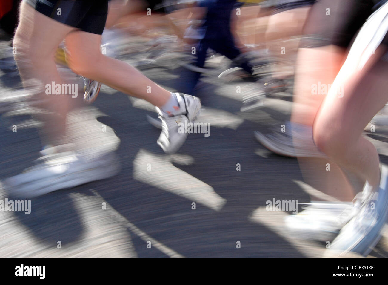 Blurred legs of runners. Stock Photo