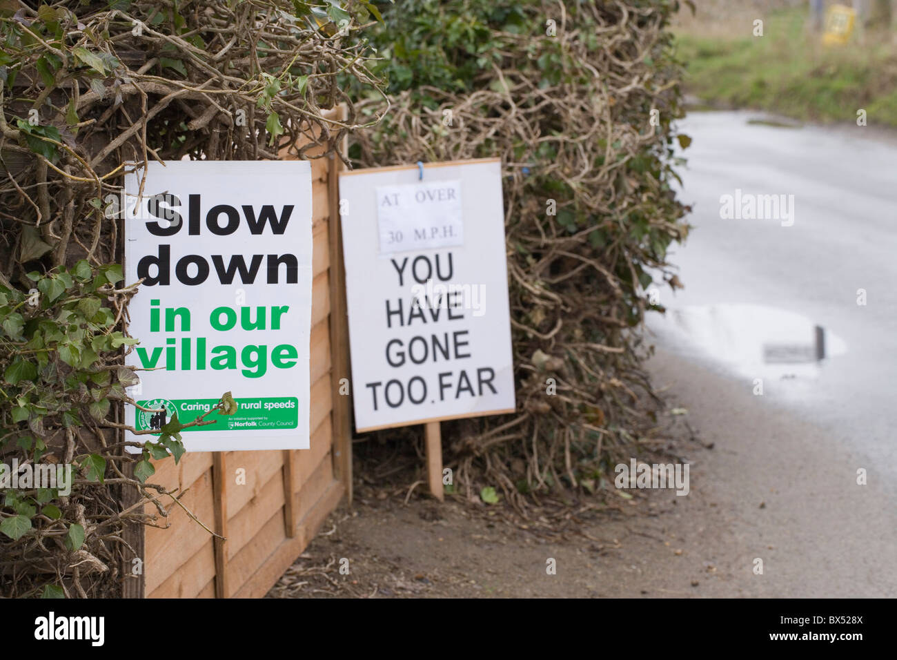 Road Signs. Plea from local residents for motorists to drive more slowly through rural village. Hickling, Norfolk. Stock Photo