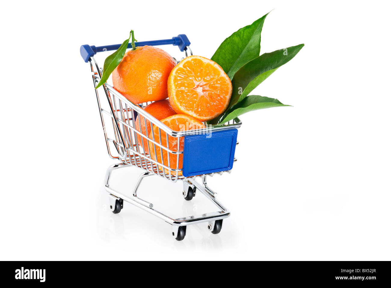 Fruit shopping. Ripe tangerines in shopping cart over white background Stock Photo