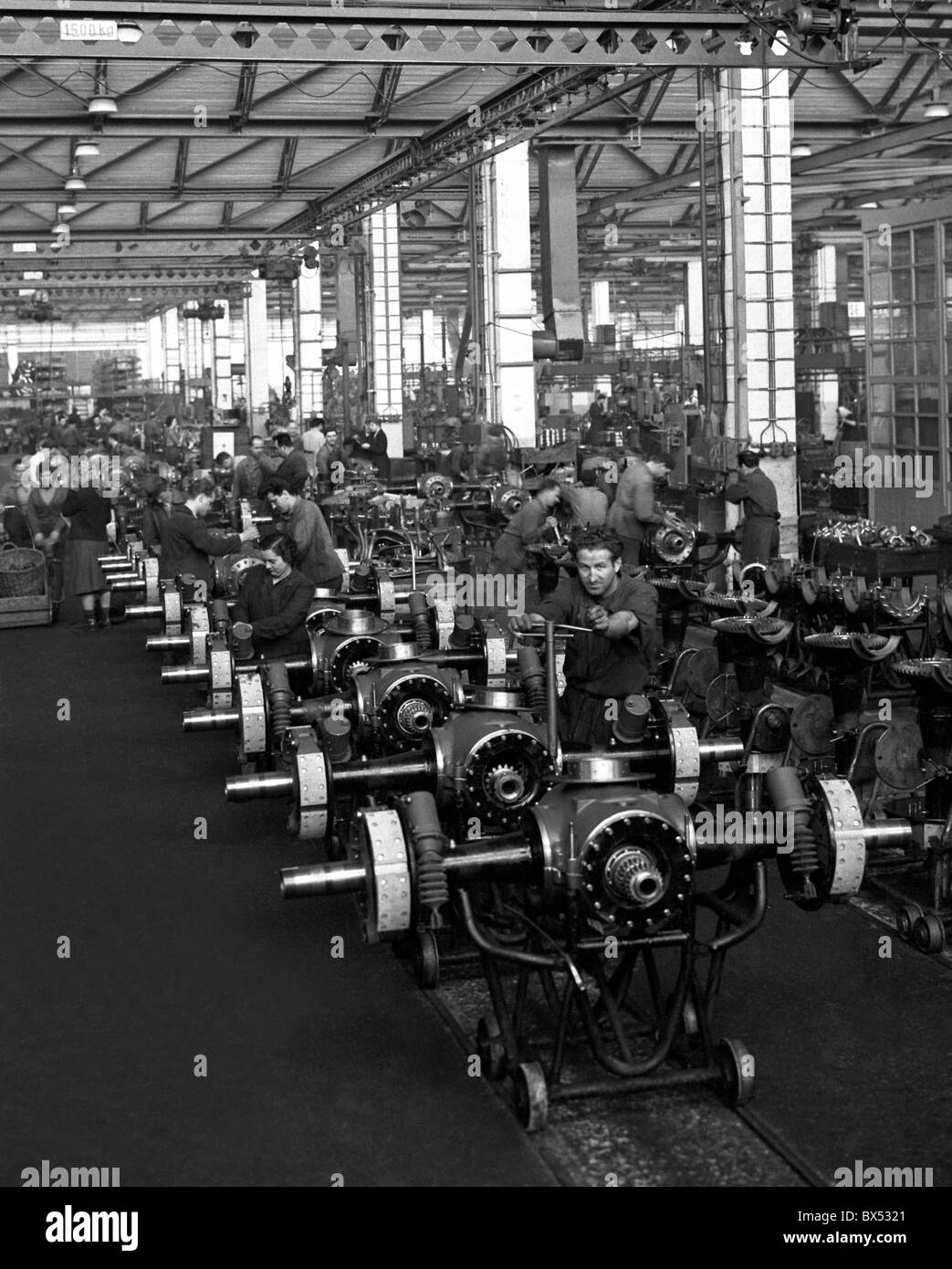 Auto workers assemble parts at Tatra plant assembly line. Koprivnice, Czechoslovakia 1960. (CTK Photo / Venek Svorcik) Stock Photo