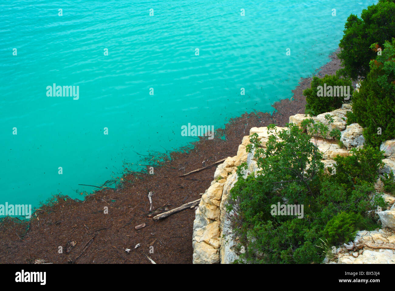 Debris washed up on the shore of Lake Sainte-Croix (Lac de Sainte-Croix) in the Verdon basin of Provence, France, Europe. Stock Photo