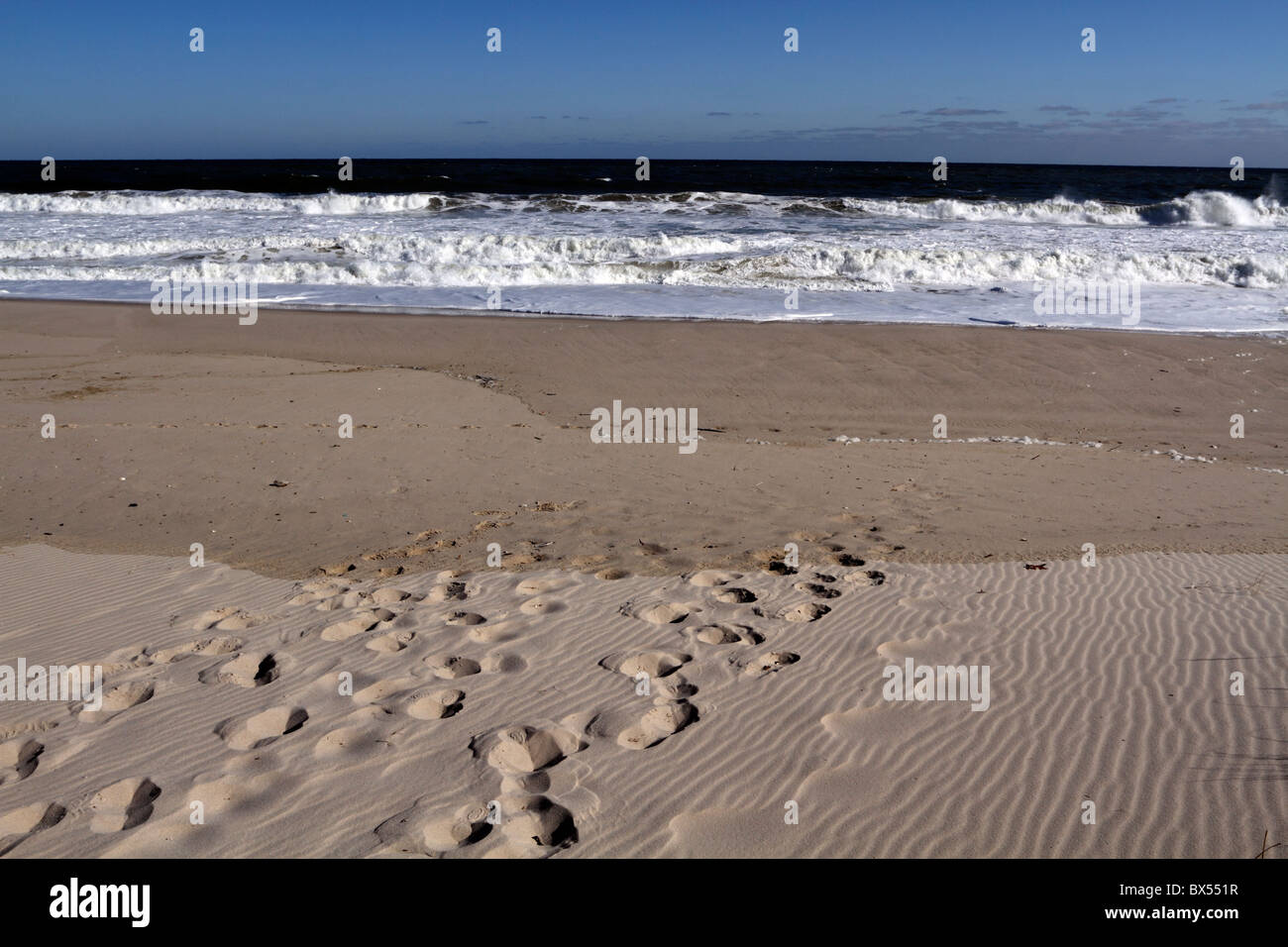 Footprints on the beach being erased by the tide. The transience of man. Lavalette, New Jersey, USA Stock Photo