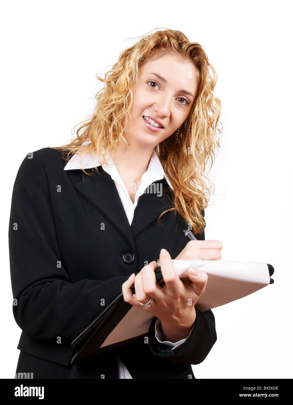 Blond, young businesswoman in black dress writing on her notepad Stock Photo