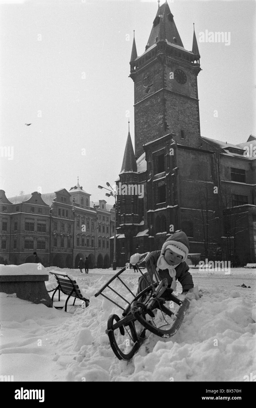 Small child with sledge at the Old Town Square after heavy snowfall hit Prague in February 1969. CTK Photo/Jiri Finda Stock Photo