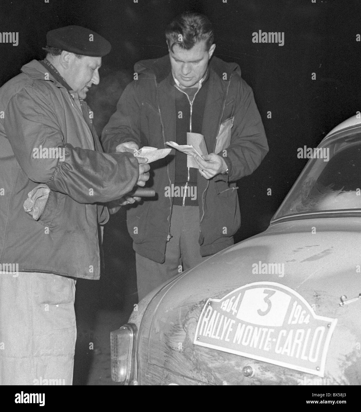 Driver of the car Eso Syrena N. Zaton of Poland with his co-driver K. Osinski do some formalities during their stop in Prague Stock Photo