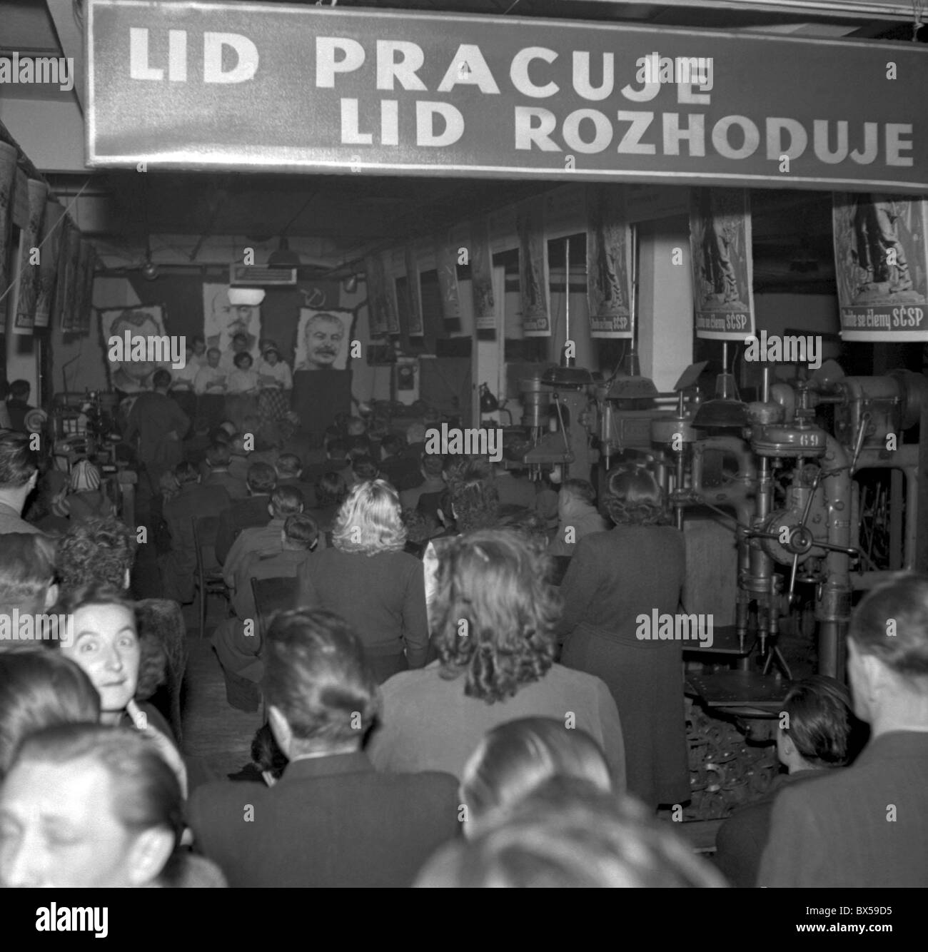 Prague 1949. Workers at 'Hefa' factory with Socialist propaganda banner : ' People work people decide. ' CTK Vintage Photo Stock Photo