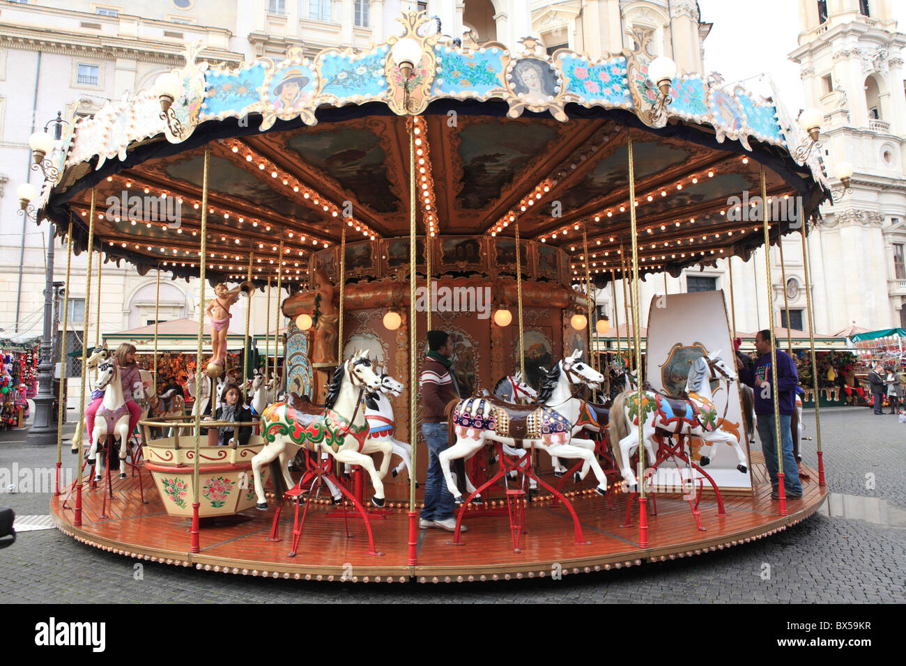 Merry go round in Italian city square, Rome Stock Photo
