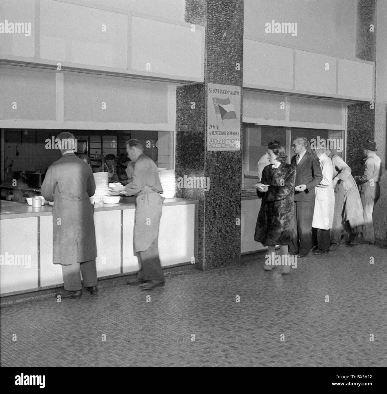 Prague - Vysocany 1949. Factory cafeteria with poster : 'With Soviet Union for peace and security.' CTK Vintage Photo Stock Photo