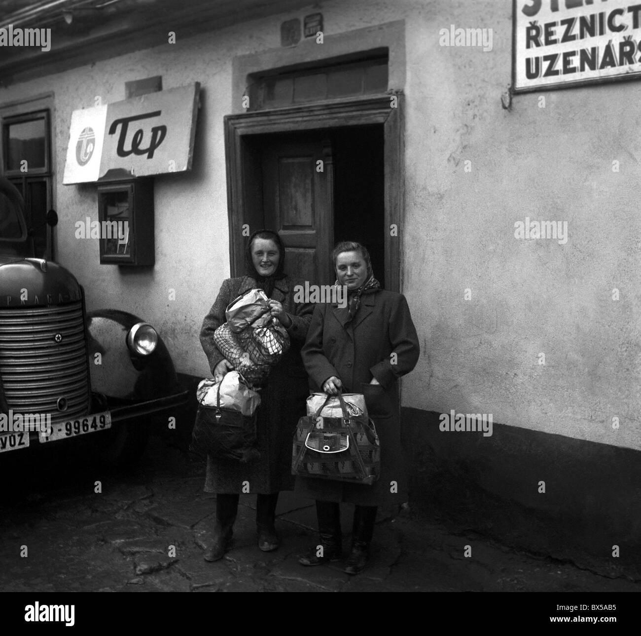 Czechoslovakia - Suchomasty 1949. Two women seem satisfied after shopping for clothes from mobile garment store. This photo was Stock Photo