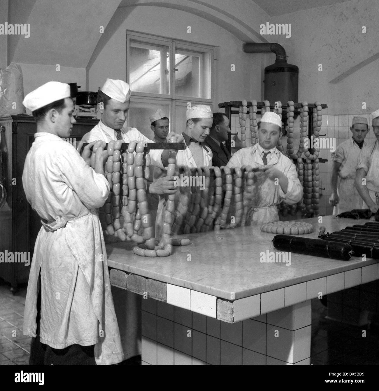 Prague 1946, butchers produce sausages in meat factory. Butcher school