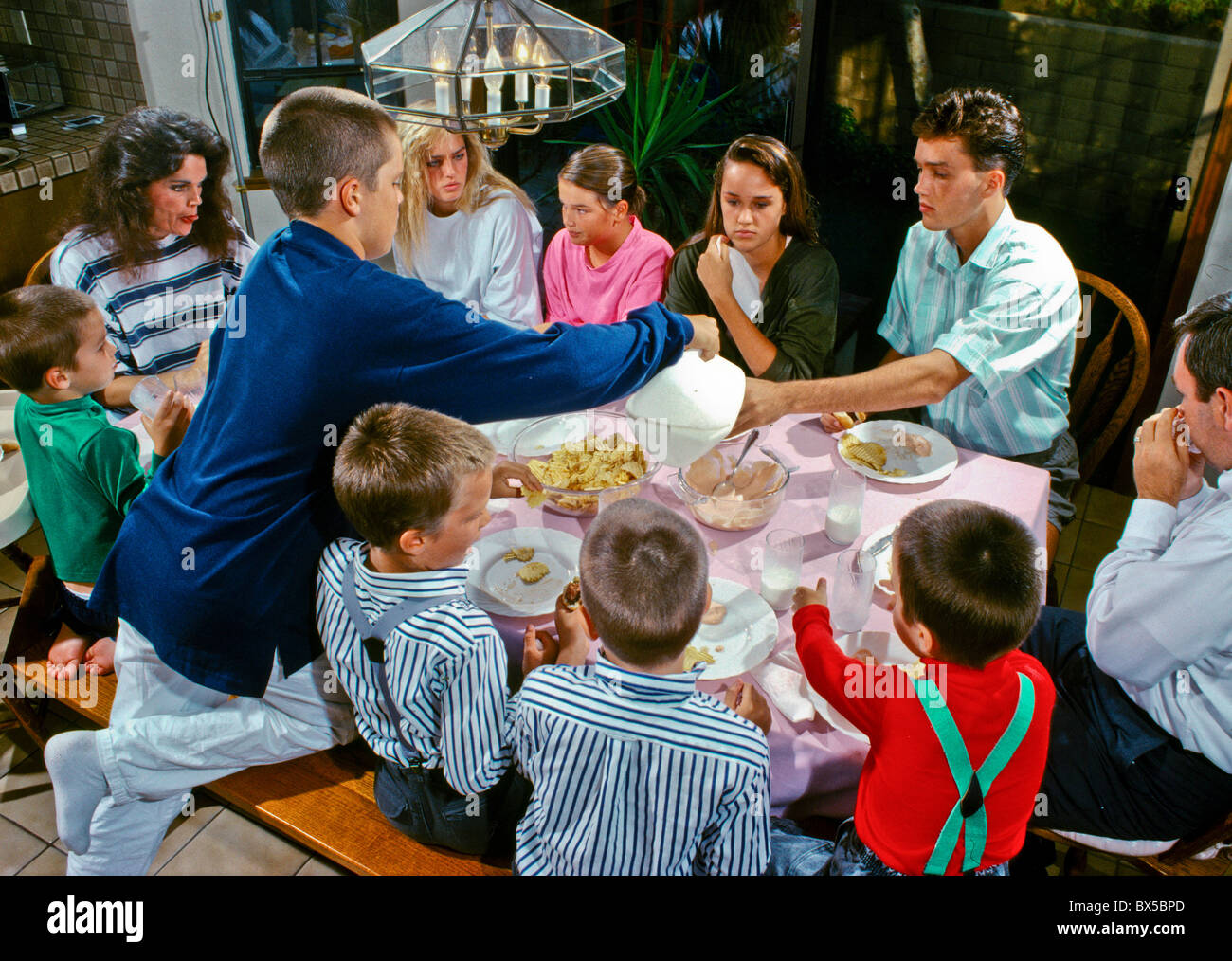A family with ten children eats dinner together in Laguna Niguel, CA
