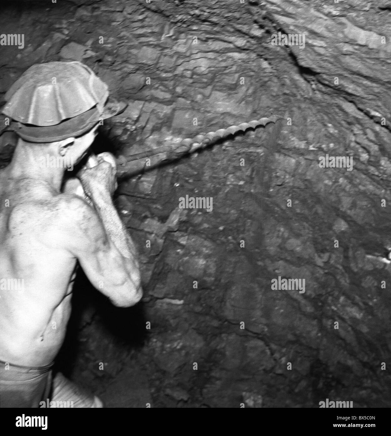 Czechoslovakia - Most 1947. Coal miner drills into coal wall before blasting. CTK Vintage Photo Stock Photo