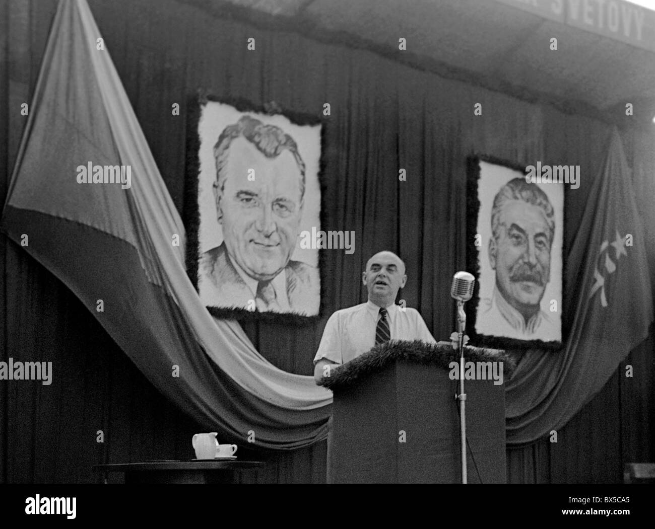Czechoslovakia - Prague 1948. Communist Minster of Culture Vaclav Kopecky with portraits of Stalin and Gottwald speaks to Stock Photo