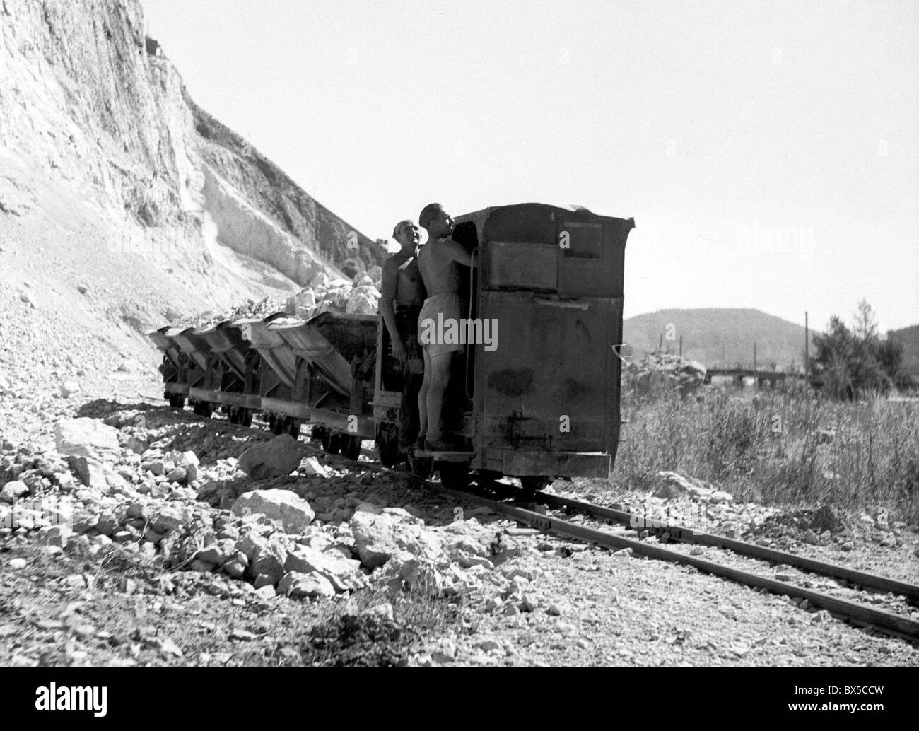 Czechoslovakia, Stramberg 1948. Limestone mine. Miners catch a ride on miniature freight train. CTK Vintage Photo Stock Photo