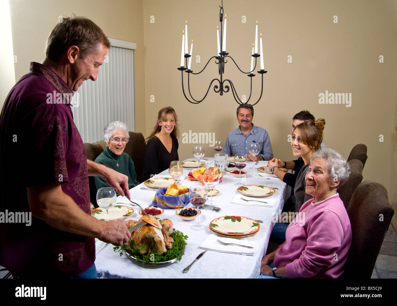 Three generations of a family gather for a traditional Thanksgiving turkey dinner in Southern California. Stock Photo