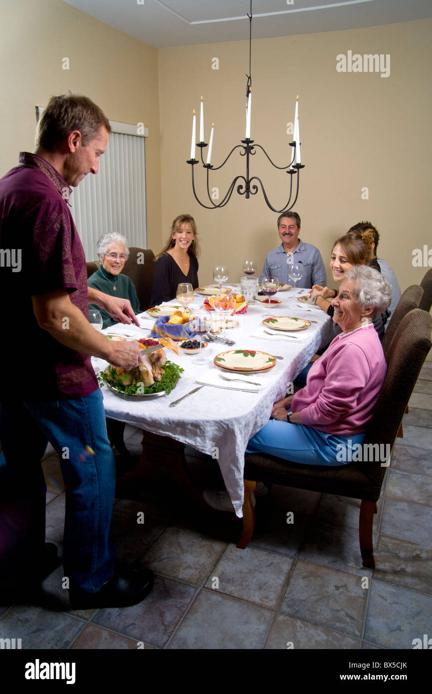 Three generations of a family gather for a traditional Thanksgiving turkey dinner in Southern California. Stock Photo