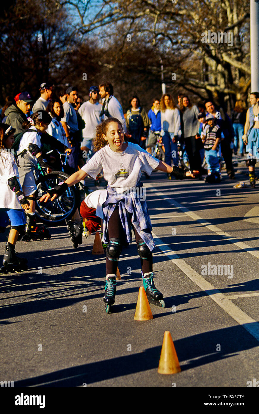 Children on rollerblade skates negotiate an obstacle course on a winter afternoon in Central Park, New York City. Stock Photo