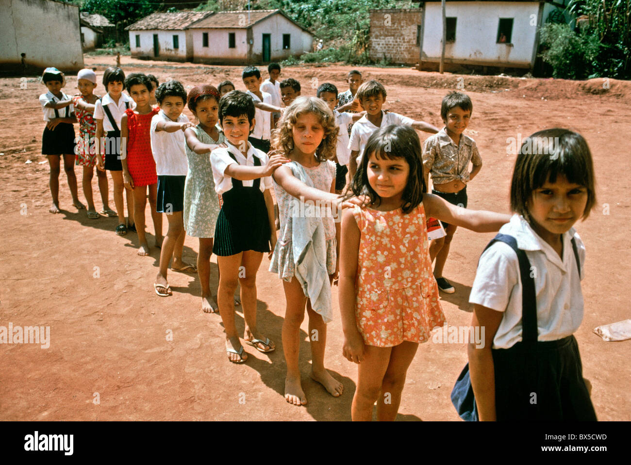 Schoolchildren line up at recess in a rural Brazilian village in Bahia province. Note uniforms on some students. Stock Photo