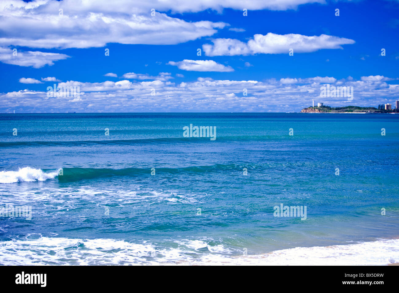 Beautiful blue ocean with small waves Point Cartwright in background Stock Photo