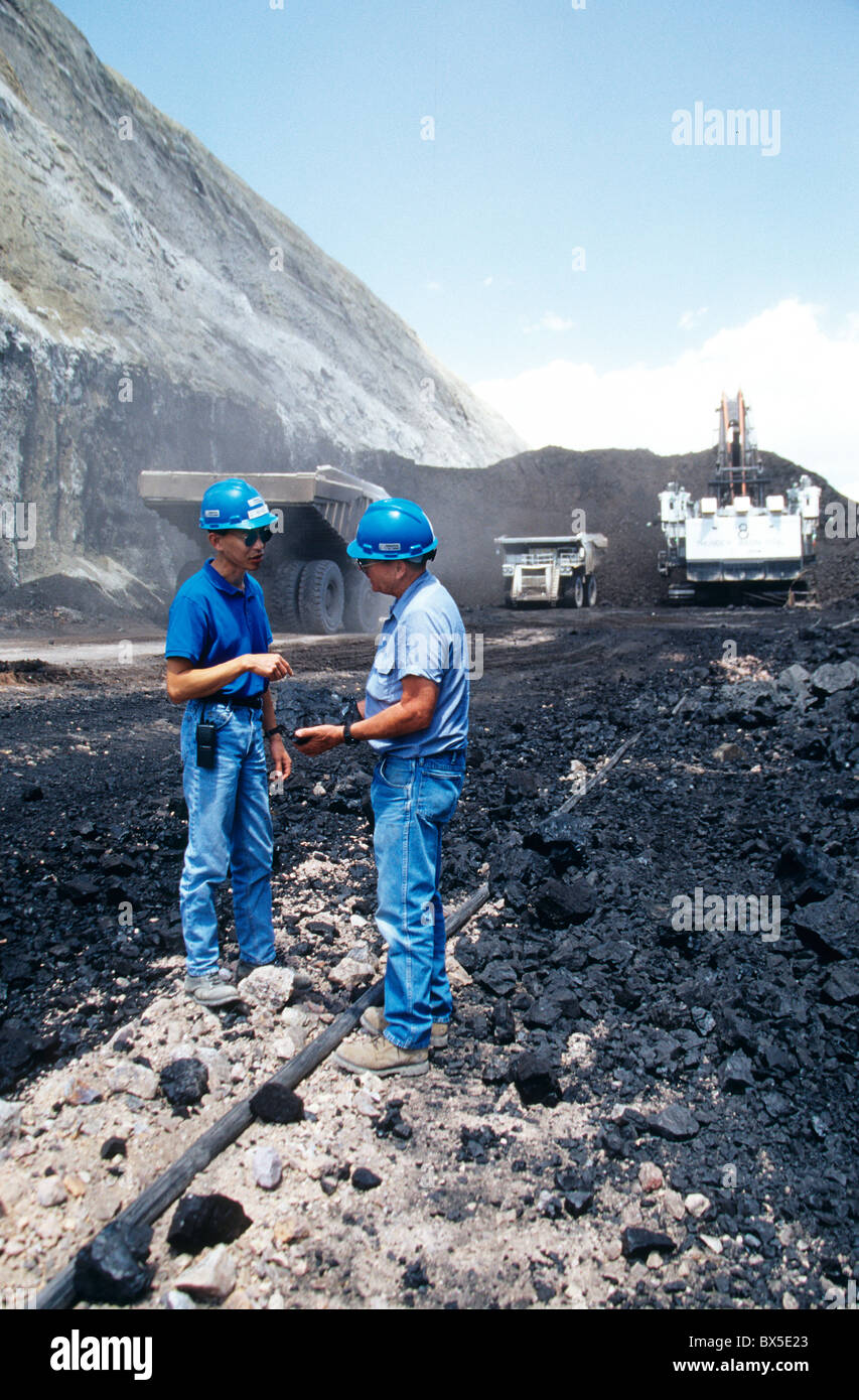 Engineer explains quality of 'coal' specimen to visitor. Stock Photo