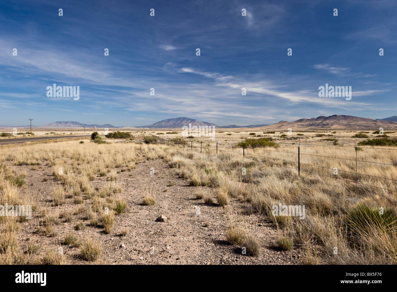 Looking down the Highway, US 54, with view of mountains in the distance in New Mexico, USA Stock