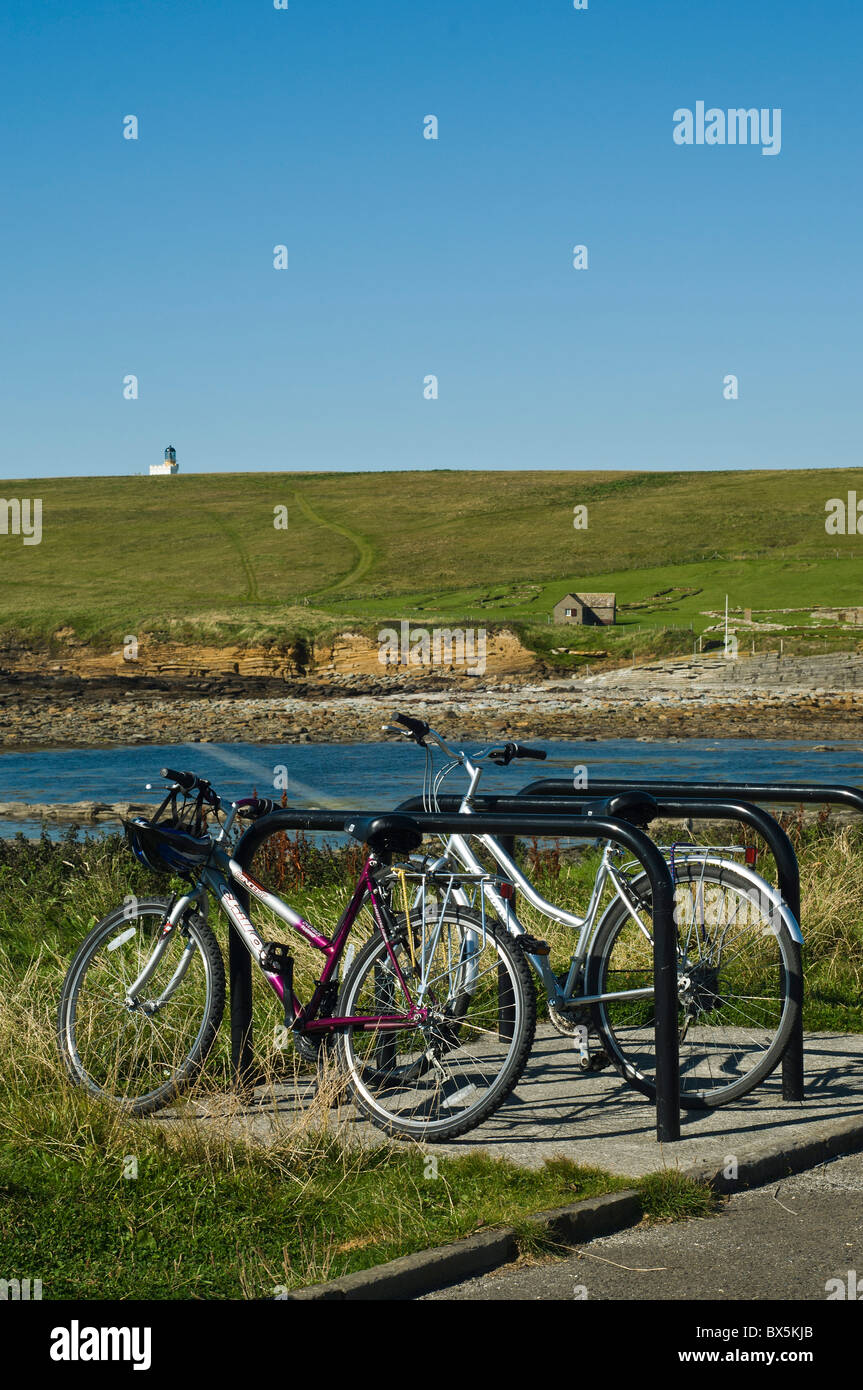 dh Brough of Birsay BIRSAY ORKNEY Tourist visitors pedal bicycles in bicycle stand cycle bikes parked uk Stock Photo