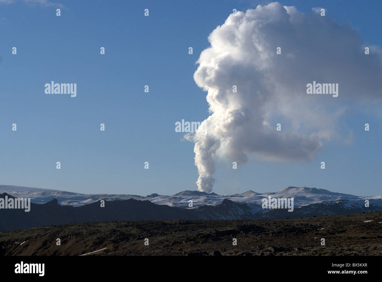 Smoke plume rising over glacier, Eyjafjallajokull volcano, Iceland, Polar Regions Stock Photo