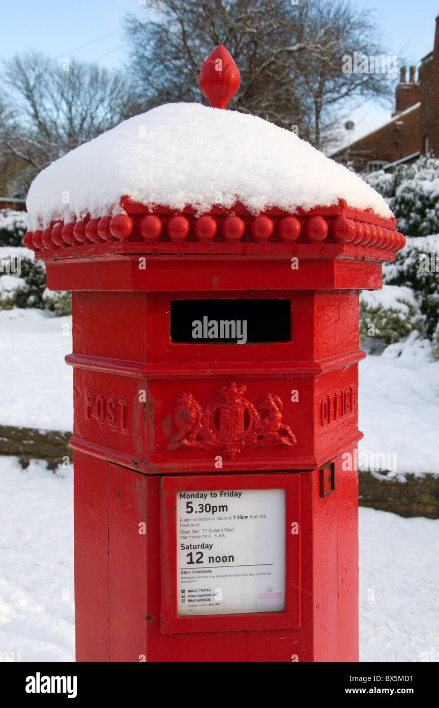 Victorian post box covered in snow at the Fairfield Moravian Settlement, Droylsden, Tameside, Manchester, England, UK Stock Photo