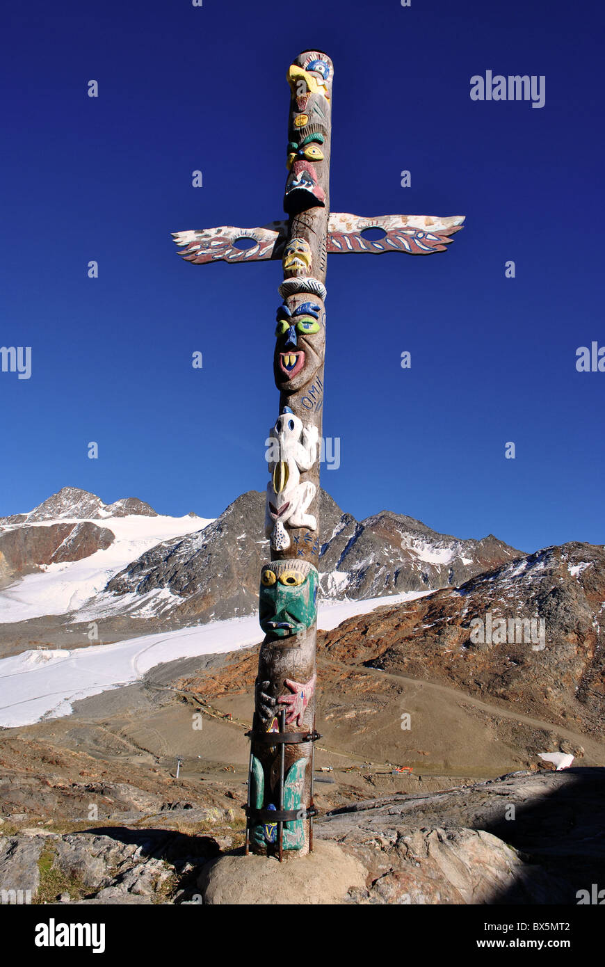 totem shaped wooden cross with human figures Stock Photo