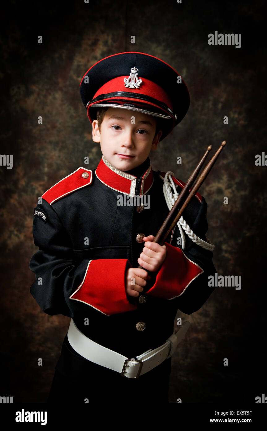 boy in a marching band uniform holding drum sticks Stock Photo Alamy