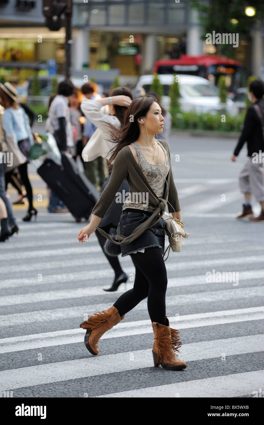 Young, fashionable Japanese women crossing the street at Shibuya Crossing, Tokyo, Japan Stock Photo